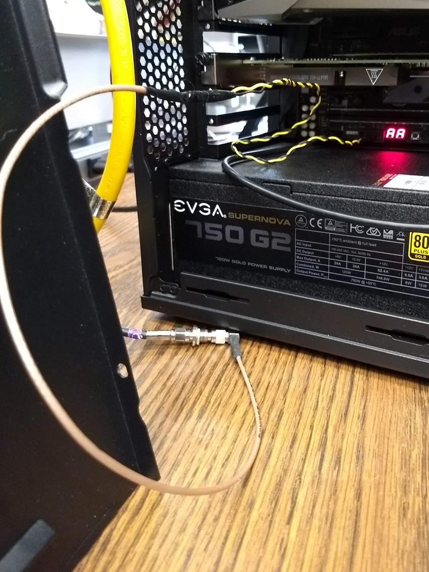 Modified coaxial cable connected to the COM port DCD and GND pins on the motherboard